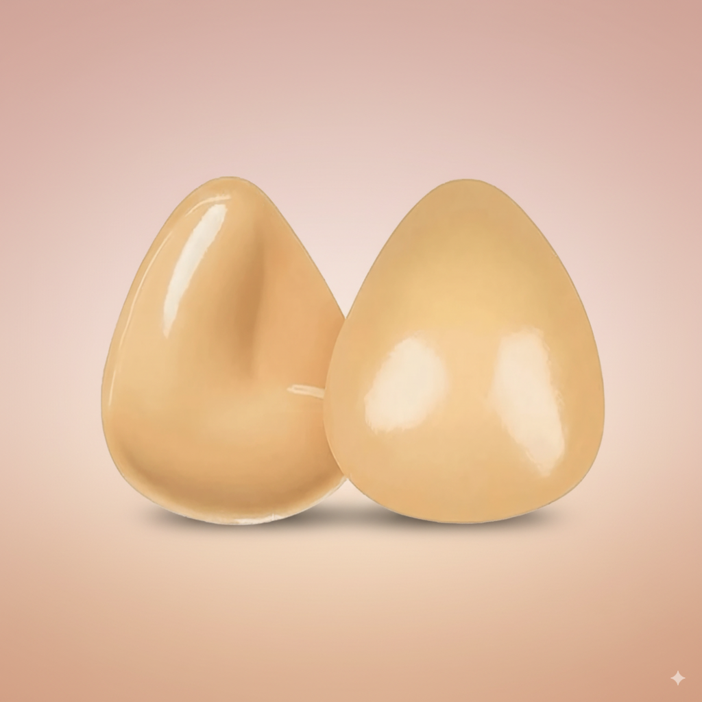 Two push up bra inserts on a gradient background